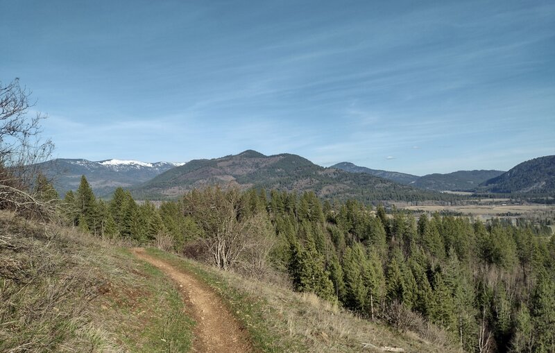 Prater Mountain (center) rises above farmlands below. Further in the distance, on the left, are snowy peaks of north Idaho's Selkirk Mountains.