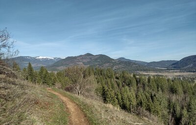 Prater Mountain (center) rises above farmlands below. Further in the distance, on the left, are snowy peaks of north Idaho's Selkirk Mountains.
