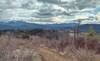 Mountains surround the flat farmlands below, in a typical northern Idaho landscape, here in Priest River country. Seen from high on Peewee Peak's John Wayne Trail.