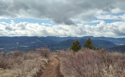 Mountains and hills everywhere, are seen looking southwest from the John Wayne Trail on the slopes of Peewee Peak.