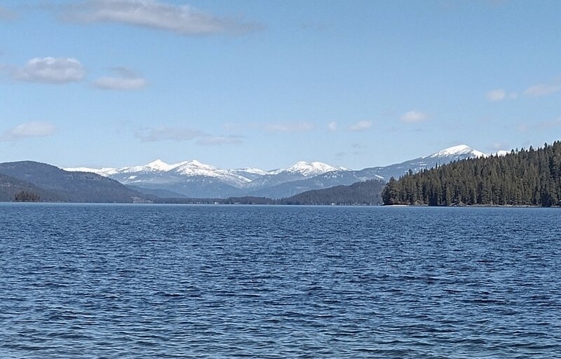 Looking north up Priest Lake (zooming in), nearby land (right) is Bartoo Island. Lookout Mountain (right) is behind Bartoo Island. Tiny Papoose Island is on the far left. All the mountains center left, are more of the Selkirks and far, far, away.