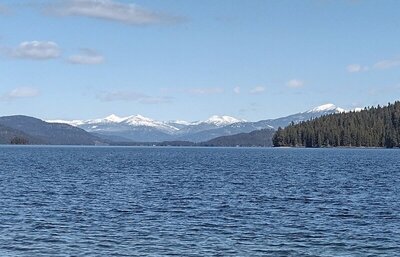 Looking north up Priest Lake (zooming in), nearby land (right) is Bartoo Island. Lookout Mountain (right) is behind Bartoo Island. Tiny Papoose Island is on the far left. All the mountains center left, are more of the Selkirks and far, far, away.