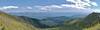 Panorama view of the Selkirk Mountains. Seen from the saddle between Helmer Mountain's summit (left), and Helmer Mountain's south shoulder (right). Priest Lake (center right) is tucked in behind the middle ridge.