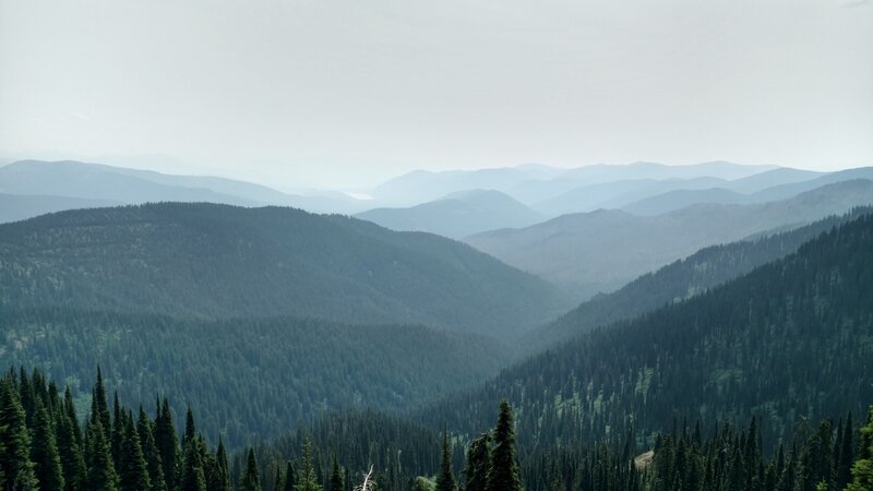 The ridges of Selkirk Mountains, with Upper Priest Lake, the flat white spot among the far ridges, just left of center. Upper Priest Lake is 12 miles away, to the southeast.