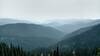 The ridges of Selkirk Mountains, with Upper Priest Lake, the flat white spot among the far ridges, just left of center. Upper Priest Lake is 12 miles away, to the southeast.