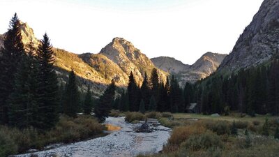 Last light of the evening on the cliffs, as the sun drops below the mountains.  Here, the New Fork River runs through the meadows and brush of New Fork Park, a good place to camp.