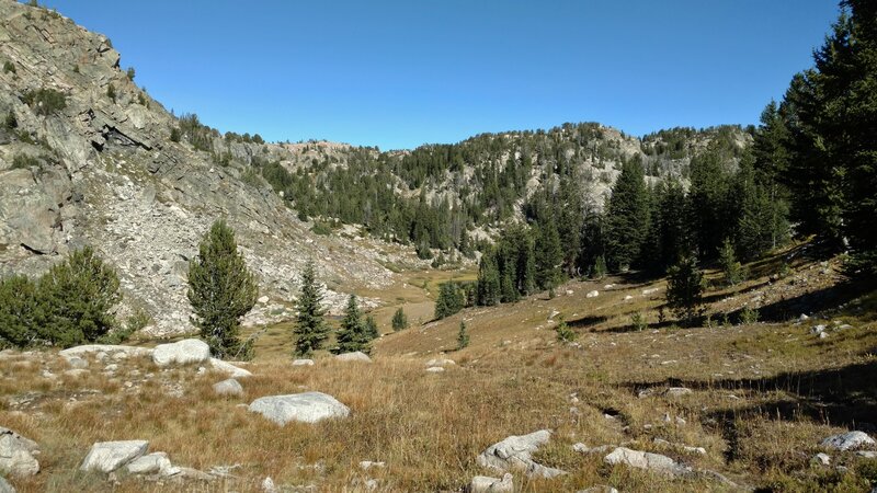 Beautiful, rugged, rocky, grassy terrain dotted with trees, typical of the Doubletop Mountain Trail east of Palmer Lake.