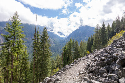 Traversing a lower talus slope on the descent, the trail gazes directly south into the dramatic, U-shaped glacial canyon of the West Fork Wallowa River.