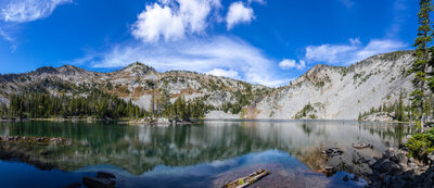 Opening onto pristine Chimney Lake at 7,628 ft, an amphitheater of glaciated granodiorite crags and sprawling talus slopes frames the crystalline turquoise waters.