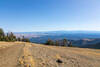 Looking east from the Mount Howard Summit Loop Trail at 8,240 ft, the alpine plateau falls away to reveal an expansive vista across the rolling, stepped basalt canyonlands of the Columbia Plateau.