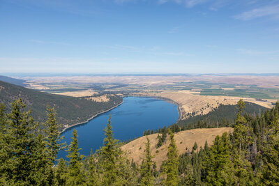 Gazing north from the Tramway Upper Terminal Overlook at 8,113 ft, an iconic bird's-eye perspective reveals the sapphire waters of Wallowa Lake resting over 3,700 ft below.