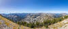 From an upper southwest switchback on Eagle Cap at 9,132 ft, an expansive 180-degree panorama looks across the deep glaciated trough of East Fork Eagle Creek toward the sharp horn of Needle Point (9,070 ft) and Hidden Lake.