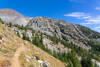 Traversing an open, sunlit switchback at 7,196 ft, the Ice Lake Trail climbs steadily toward the high glacial basin above Adam Creek.